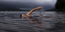 person swimming in a lake