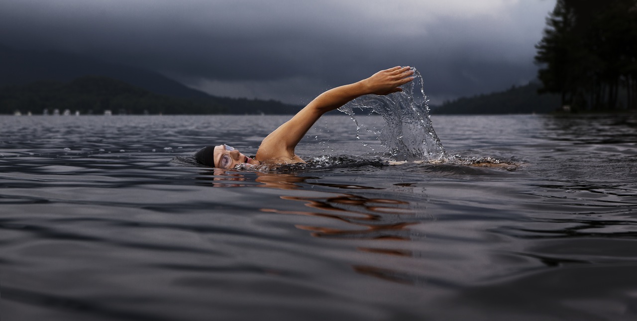 person swimming in a lake