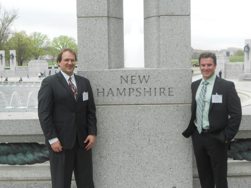 two men in front of New Hampshire stone in DC