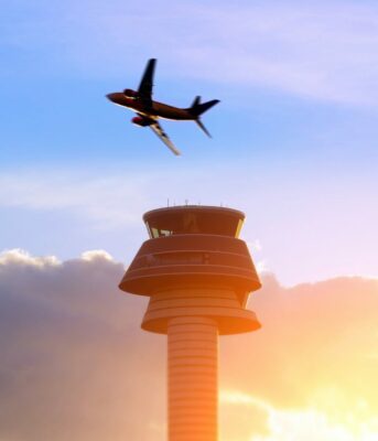 faa reauthorization -- commercial plane takes off, flying over airport tower